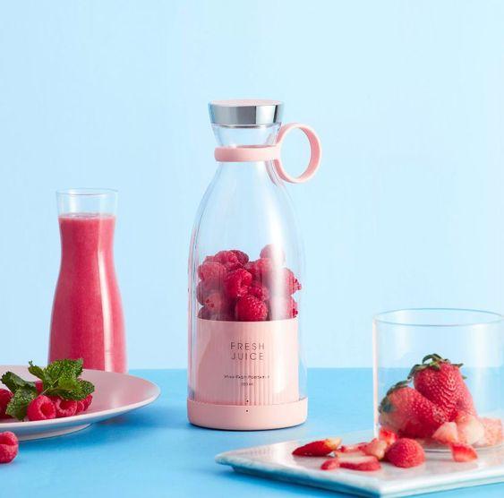 Portable rechargeable juice blender bottle with strawberry juice
